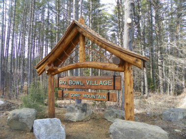 Custom rustic log sign holder with twig woodwork and cedar shake roof at Ski Bowl Village at Gore Mountain by Adirondack LogWorks