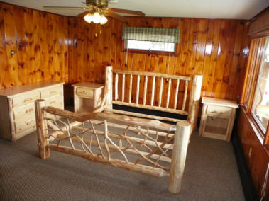 Custom rustic log bed with twig woodwork, log dresser, and log night stands by Adirondack LogWorks