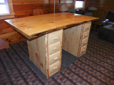 Custom rustic log kitchen island with log trim and live-edge counter top by Adirondack LogWorks