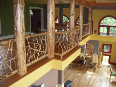 Custom rustic log posts and twig loft railings by Adirondack LogWorks