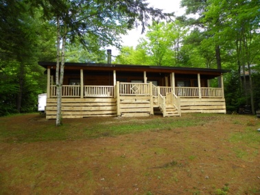 Custom rustic log railing, siding, stair, and gate woodwork by Adirondack LogWorks