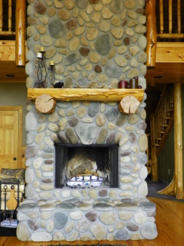 Custom rustic log mantel by Adirondack LogWorks