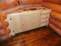 Custom-made rustic log cabinet with log trim in a log home by Adirondack LogWorks