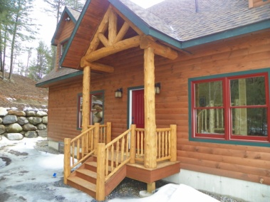 Custom rustic log truss and entryway woodwork by Adirondack LogWorks
