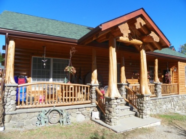 Custom log truss, entryway, and railings with rustic flair woodwork by Adirondack LogWorks