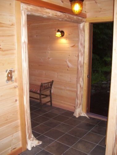 Custom rustic log flare-based entryway woodwork by Adirondack LogWorks