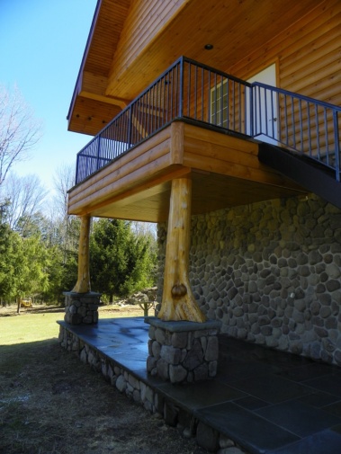 Custom rustic log home entryway with flair woodwork by Adirondack LogWorks