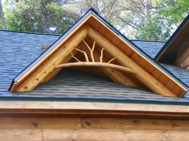 Custom rustic log home truss and entryway twig woodwork by Adirondack LogWorks
