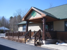 The Girl Scouts building in Queensbury, N.Y., featuring an entryway with custom rustic log railings and posts by Adirondack LogWorks