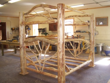 Custom rustic log canopy bed by Adirondack LogWorks