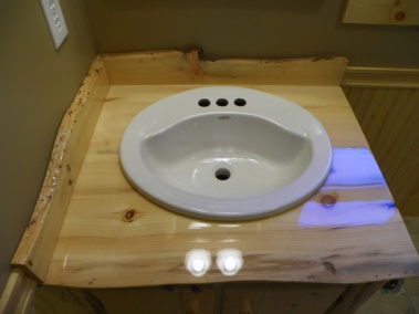 Custom rustic live-edge log vanity sink countertop by Adirondack LogWorks