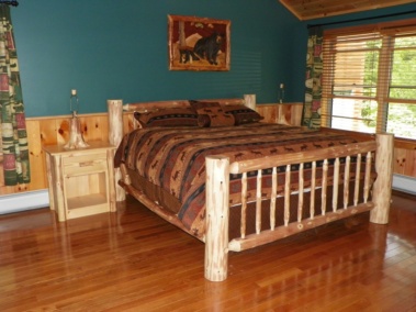 Rustic log bed, log nightstand, and log lamp decor by Adirondack LogWorks