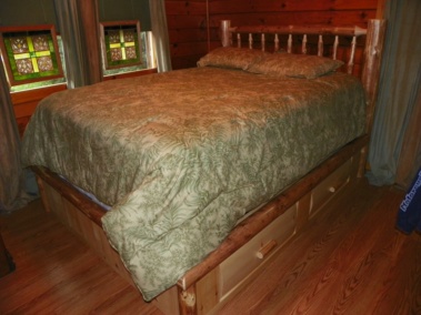 Custom rustic log king-sized bed with drawers and log trim by Adirondack LogWorks
