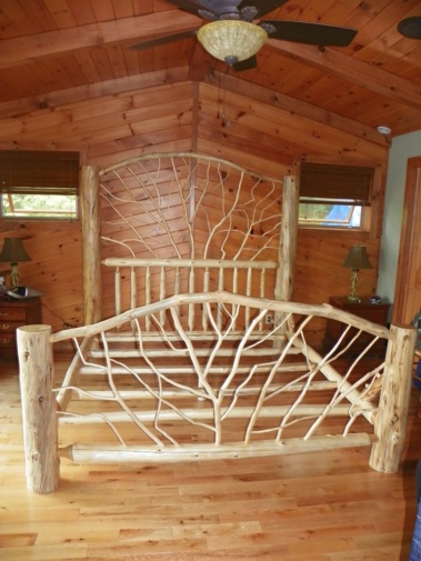 Custom-made rustic log bed with twig woodwork by Adirondack LogWorks