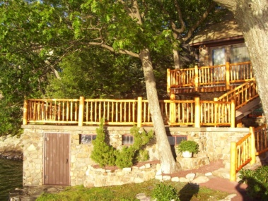 Custom rustic log railings and post woodwork by Adirondack LogWorks