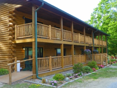 Custom rustic log railings and log handrails at a log home by Adirondack LogWorks