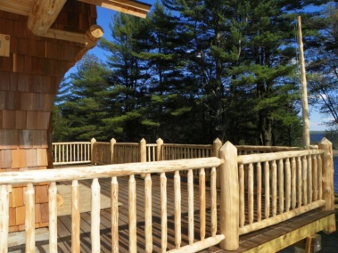 Custom rustic log railings at a log home by Adirondack LogWorks
