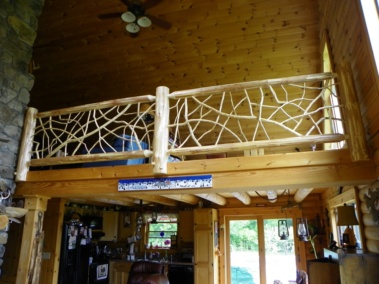 Custom rustic log loft railings with twig woodwork by Adirondack LogWorks