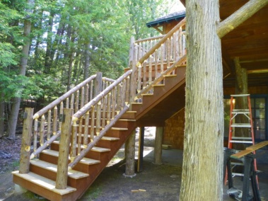 Custom rustic bark-on log railing woodwork by Adirondack LogWorks