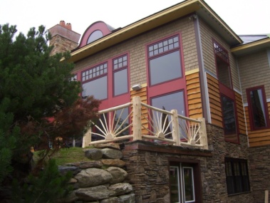 Custom rustic log railing sunburst woodwork by Adirondack LogWorks