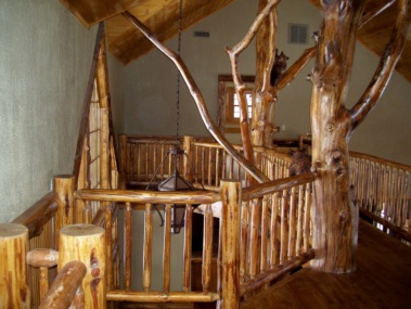 Custom rustic log railings at a log home by Adirondack LogWorks