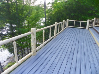 Custom rustic log railings with cable rail by Adirondack LogWorks