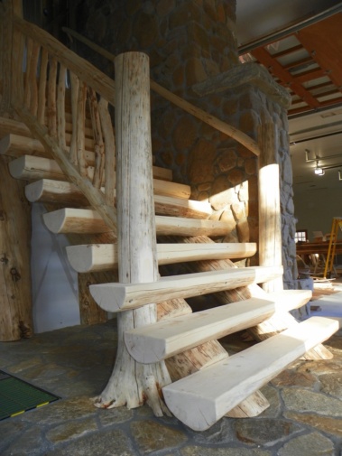 Custom rustic flair-based log stairs and railings by Adirondack LogWorks