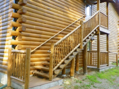 Custom log stair, railing, and post rustic woodwork by Adirondack LogWorks
