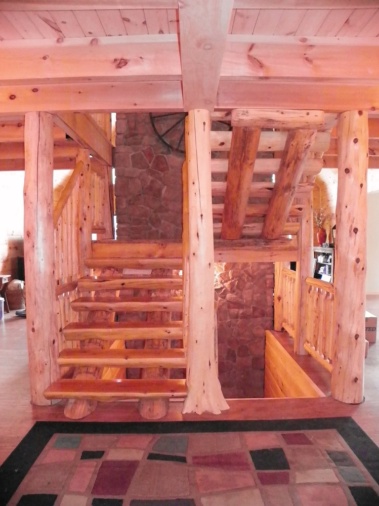 Custom rustic log stairs and flair-based log post woodwork by Adirondack LogWorks