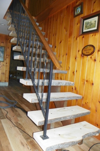 Custom rustic live-edge log stairs by Adirondack LogWorks