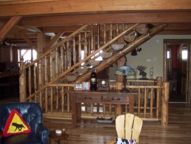 Custom rustic log stairs and railings by Adirondack LogWorks