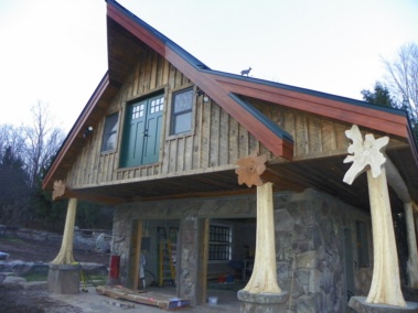 Custom log truss and entryway with rustic flair woodwork by Adirondack LogWorks