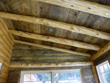 Custom rustic log trusses in a log home breakfast nook by Adirondack LogWorks