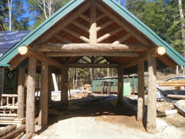 Custom bark-on rustic log truss woodwork by Adirondack LogWorks