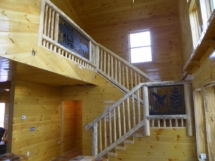 Custom rustic square log loft and stair railings by Adirondack LogWorks