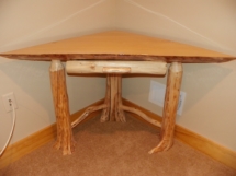 Custom rustic log corner table with twig supports and liquid glass top by Adirondack LogWorks