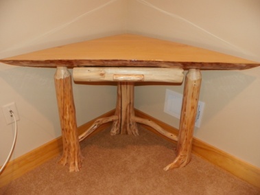 Custom rustic log corner table with twig supports and liquid glass top by Adirondack LogWorks