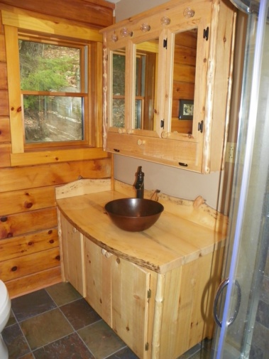 Custom rustic log vanity with live-edge woodwork and medicine cabinet furniture by Adirondack LogWorks