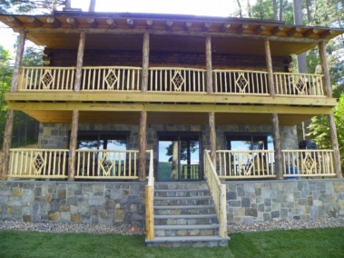 Custom rustic log railings and tall diamond twig woodwork by Adirondack LogWorks