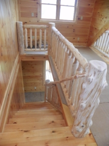 Custom rustic log railings, handrail, and twisted post by Adirondack LogWorks