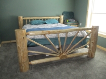 Custom rustic log bed with sunburst footboard by Adirondack LogWorks