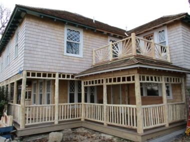 Custom rustic log railings and transom rail and sunburst rails by Adirondack LogWorks