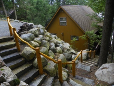 Custom rustic outdoor log railings by Adirondack LogWorks