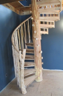 Custom rustic log spiral stairs and log railings by Adirondack LogWorks