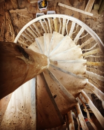 Custom rustic log spiral staircase and log railings by Adirondack LogWorks