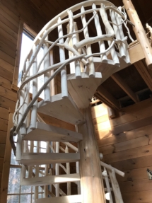Custom rustic log spiral stairs, log spiral staircase with custom rustic log twig railings by Adirondack LogWorks