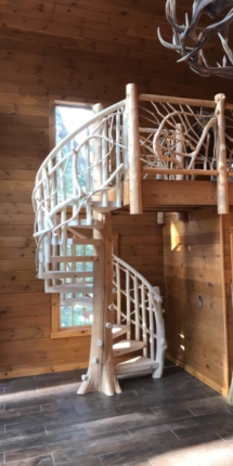 Custom rustic log spiral stairs, log spiral staircase with custom rustic log twig railings by Adirondack LogWorks
