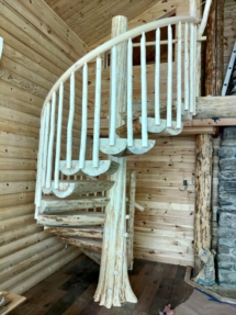 Custom rustic log spiral stairs, log spiral staircase with custom rustic log railings by Adirondack LogWorks