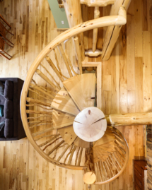 Custom rustic log split spiral stairs, log split spiral staircase with custom rustic log twig railings by Adirondack LogWorks