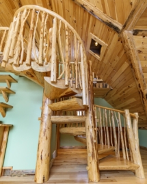 Custom rustic log split spiral stairs, log split spiral staircase with custom rustic log twig railings by Adirondack LogWorks
